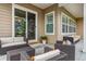 Cozy covered patio with comfortable wicker furniture, perfect for outdoor lounging and entertaining at 8890 S Quatar Ct, Aurora, CO 80016