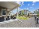 Relaxing covered patio with gravel landscaping and a view of the fenced backyard and community at 8890 S Quatar Ct, Aurora, CO 80016