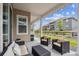 Charming covered patio with outdoor seating, offering a view of the landscaped backyard and neighboring homes at 8890 S Quatar Ct, Aurora, CO 80016