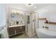 Modern bathroom with a soaking tub, walk-in shower, and double vanity at 190 W 1St Ave, Broomfield, CO 80020