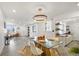 Open concept dining room with a glass-top table, white chairs, and kitchen views at 190 W 1St Ave, Broomfield, CO 80020