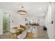 Open concept dining area with glass table, white chairs, and view into living room at 190 W 1St Ave, Broomfield, CO 80020