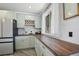 Modern kitchen with light cabinets, butcher block countertops and stylish backsplash at 190 W 1St Ave, Broomfield, CO 80020