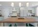 Updated kitchen featuring light green cabinets, wood countertops, and a stainless steel refrigerator at 190 W 1St Ave, Broomfield, CO 80020