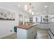 Modern kitchen with light green cabinets, butcher block island, and stainless steel appliances at 190 W 1St Ave, Broomfield, CO 80020