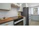 Modern kitchen with stainless steel appliances and wood countertops at 190 W 1St Ave, Broomfield, CO 80020