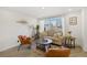 Living room features a beige couch, two accent chairs, and a coffee table at 190 W 1St Ave, Broomfield, CO 80020