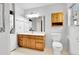 Bathroom featuring a bright window, a toilet, and a mirror at 31819 Rocky Village Dr # 418, Evergreen, CO 80439