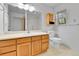 Bathroom featuring a large countertop, mirror, a window, a toilet, and a shower at 31819 Rocky Village Dr # 418, Evergreen, CO 80439