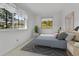 Bright bedroom featuring a tree-filled window view, a bed and neutral-toned decor at 31819 Rocky Village Dr # 418, Evergreen, CO 80439