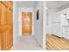 Inviting entryway featuring a wood door, coat closet and bright white walls at 31819 Rocky Village Dr # 418, Evergreen, CO 80439