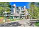 Inviting condo complex with stone accents and a covered entryway surrounded by lush landscaping at 31819 Rocky Village Dr # 418, Evergreen, CO 80439