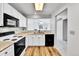 Efficient kitchen with white cabinetry, laminate countertops, and an open layout to the living area at 31819 Rocky Village Dr # 418, Evergreen, CO 80439