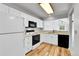 Functional kitchen features white cabinets, laminate counters, and an open layout for easy living at 31819 Rocky Village Dr # 418, Evergreen, CO 80439
