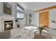 Cozy living room showcasing fireplace, large windows, and wood accents, creating a warm ambiance at 31819 Rocky Village Dr # 418, Evergreen, CO 80439
