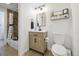 Bathroom features a vanity with doors, a toilet, tiled floors, and a tub with shower at 7335 E Quincy Ave # 107, Denver, CO 80237