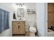 Charming bathroom with a wood vanity, modern fixtures, and decorative shelving at 7335 E Quincy Ave # 107, Denver, CO 80237