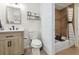 Bright bathroom features a vanity with drawers, a toilet, tiled floors, and a tub with a shower at 7335 E Quincy Ave # 107, Denver, CO 80237