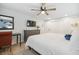 Spacious bedroom with a ceiling fan, dresser, work desk, and ample closet space at 7335 E Quincy Ave # 107, Denver, CO 80237