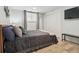 Cozy bedroom with a comfortable bed, neutral color scheme, and ample storage at 7335 E Quincy Ave # 107, Denver, CO 80237