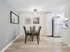 Inviting dining room with modern lighting, decor, wood floors, and seating for four at 7335 E Quincy Ave # 107, Denver, CO 80237