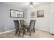 Dining room with a glass table, chairs, and modern light fixture at 7335 E Quincy Ave # 107, Denver, CO 80237