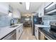 Modern kitchen featuring stainless steel appliances, white cabinets, and light blue tile backsplash at 7335 E Quincy Ave # 107, Denver, CO 80237