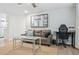 Living room featuring a leather sofa, desk, and modern decor at 7335 E Quincy Ave # 107, Denver, CO 80237