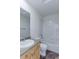 Bathroom featuring a shower-tub combo, neutral tiling, and wood vanity at 2550 Winding River Dr # F2, Broomfield, CO 80023