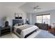 Main bedroom featuring a ceiling fan, large window, and neutral decor at 2550 Winding River Dr # F2, Broomfield, CO 80023