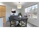 Dining room with large window, gray round table, and a light fixture at 2550 Winding River Dr # F2, Broomfield, CO 80023