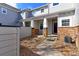 Exterior view of a townhome with gray siding and red brick accents at 2550 Winding River Dr # F2, Broomfield, CO 80023