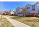 Well-maintained two-story townhome features a manicured lawn and inviting walkway at 2550 Winding River Dr # F2, Broomfield, CO 80023