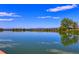 Scenic lake view reflecting the sky and trees on a clear day at 2550 Winding River Dr # F2, Broomfield, CO 80023