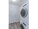 Laundry room with stacked washer and dryer and a white door at 2550 Winding River Dr # F2, Broomfield, CO 80023