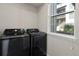 Laundry room with modern black washer and dryer units at 1330 Independence St # 2, Lakewood, CO 80215