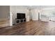 Open-concept living room featuring hardwood floors, neutral paint, and seamless transition to the kitchen at 1330 Independence St # 2, Lakewood, CO 80215