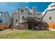 Back exterior featuring a deck, patio, yard, and home architectural style at 14170 W Warren Dr, Lakewood, CO 80228