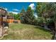 Large yard with trees, deck stairs, privacy fence and plenty of space at 14170 W Warren Dr, Lakewood, CO 80228