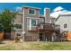 View of home backyard with patio, deck, and lush green lawn at 14170 W Warren Dr, Lakewood, CO 80228