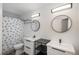 This bathroom features double sinks, modern fixtures, and a shower with unique curtain at 14170 W Warren Dr, Lakewood, CO 80228