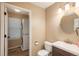 Bathroom with stacked washer/dryer, and modern vanity at 14170 W Warren Dr, Lakewood, CO 80228