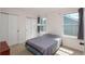 This bedroom features two windows, good light, and neutral carpet at 14170 W Warren Dr, Lakewood, CO 80228