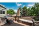 Relaxing deck with a grill, a wicker couch set, and an umbrella for shade at 14170 W Warren Dr, Lakewood, CO 80228