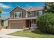 Charming two-story home with a brick and siding exterior, complemented by a well-maintained lawn and driveway at 14170 W Warren Dr, Lakewood, CO 80228