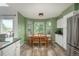 Inviting eat-in kitchen with white cabinets, stainless appliances, and a bay window dining area at 14170 W Warren Dr, Lakewood, CO 80228