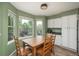 Sunny breakfast nook features a bay window and dining area with white cabinets at 14170 W Warren Dr, Lakewood, CO 80228