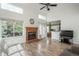 Cozy living room features high ceilings, a brick fireplace, and lots of natural light for relaxation and entertainment at 14170 W Warren Dr, Lakewood, CO 80228