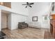 Open-concept living area offers vaulted ceilings, wood floors and a brick fireplace at 14170 W Warren Dr, Lakewood, CO 80228