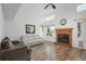 Inviting living room features a brick fireplace, lots of natural light, and cozy seating, creating an inviting atmosphere at 14170 W Warren Dr, Lakewood, CO 80228
